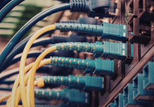 CommX Networks technician installing structured cabling in Fort Myers warehouse